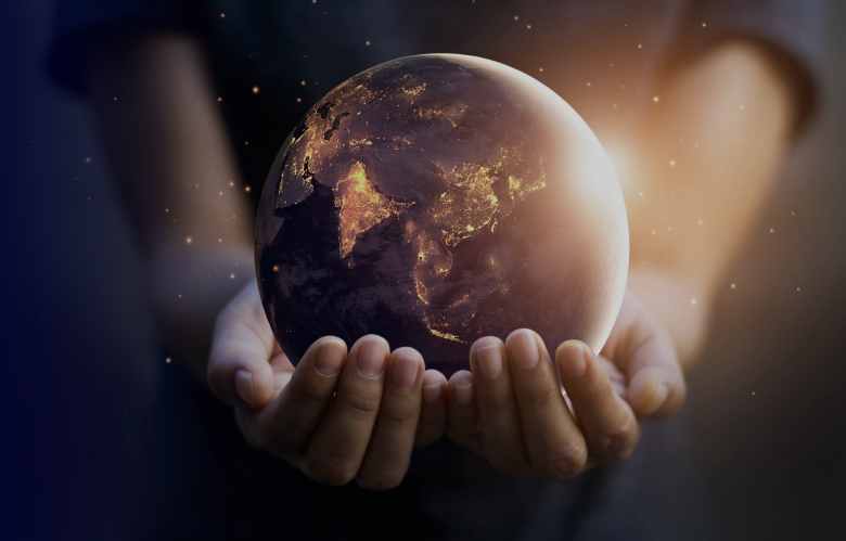 A miniature earth held in human hands, symbolizing care and support for our planet.